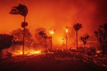 The Palisades Fire ravages a neighborhood amid high winds in the Pacific Palisades neighborhood of Los Angeles on 7 January 2025.Photograph: Ethan Swope/AP