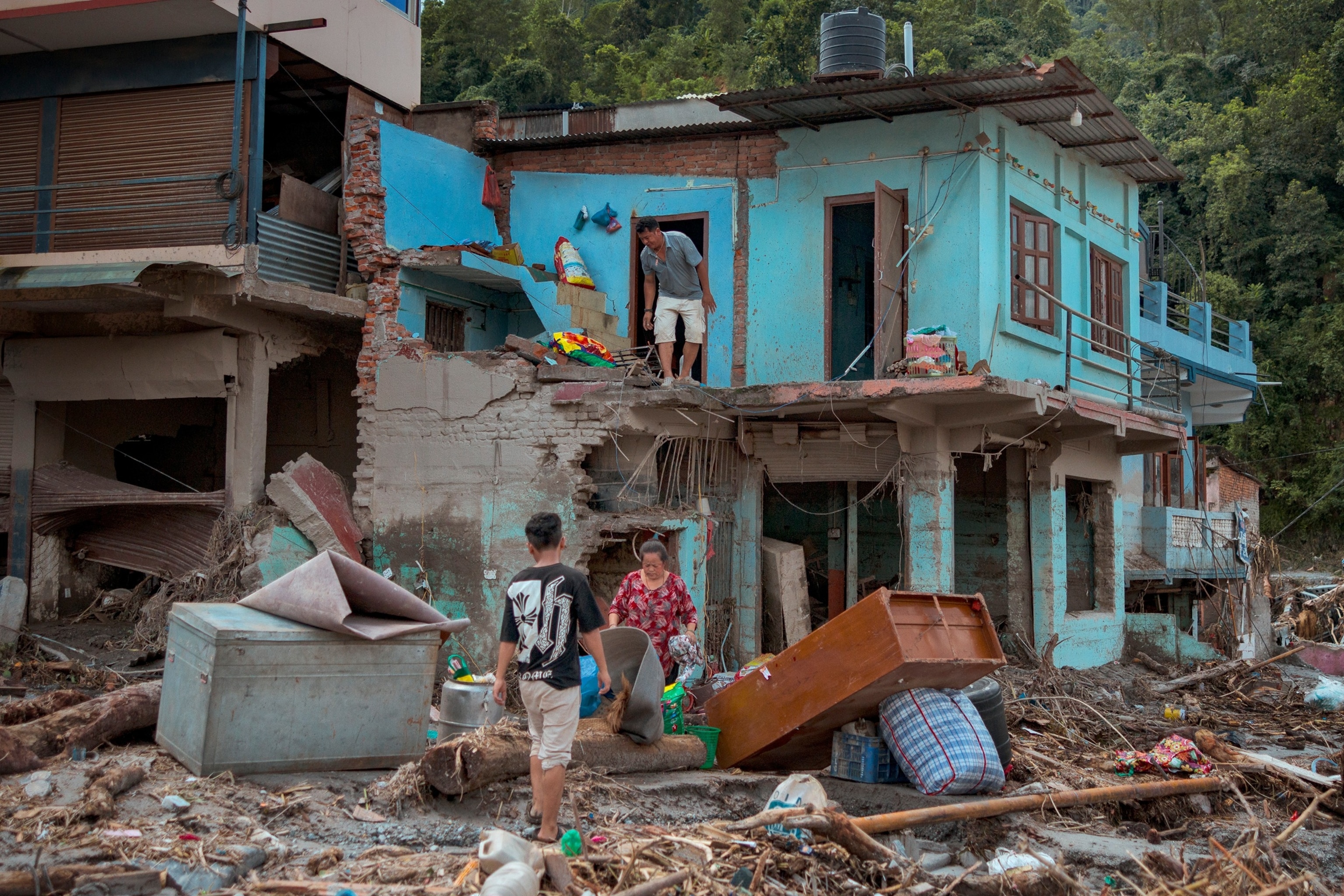 Residents salvage belongings from their destroyed home following flash floods, August 28, 2026 in Devighat, Nepal.Ezra Acayan/Getty Images