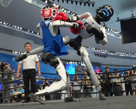 Robots can run fast or box, but they can’t do both.Photograph: Achmad Ibrahim/AP
