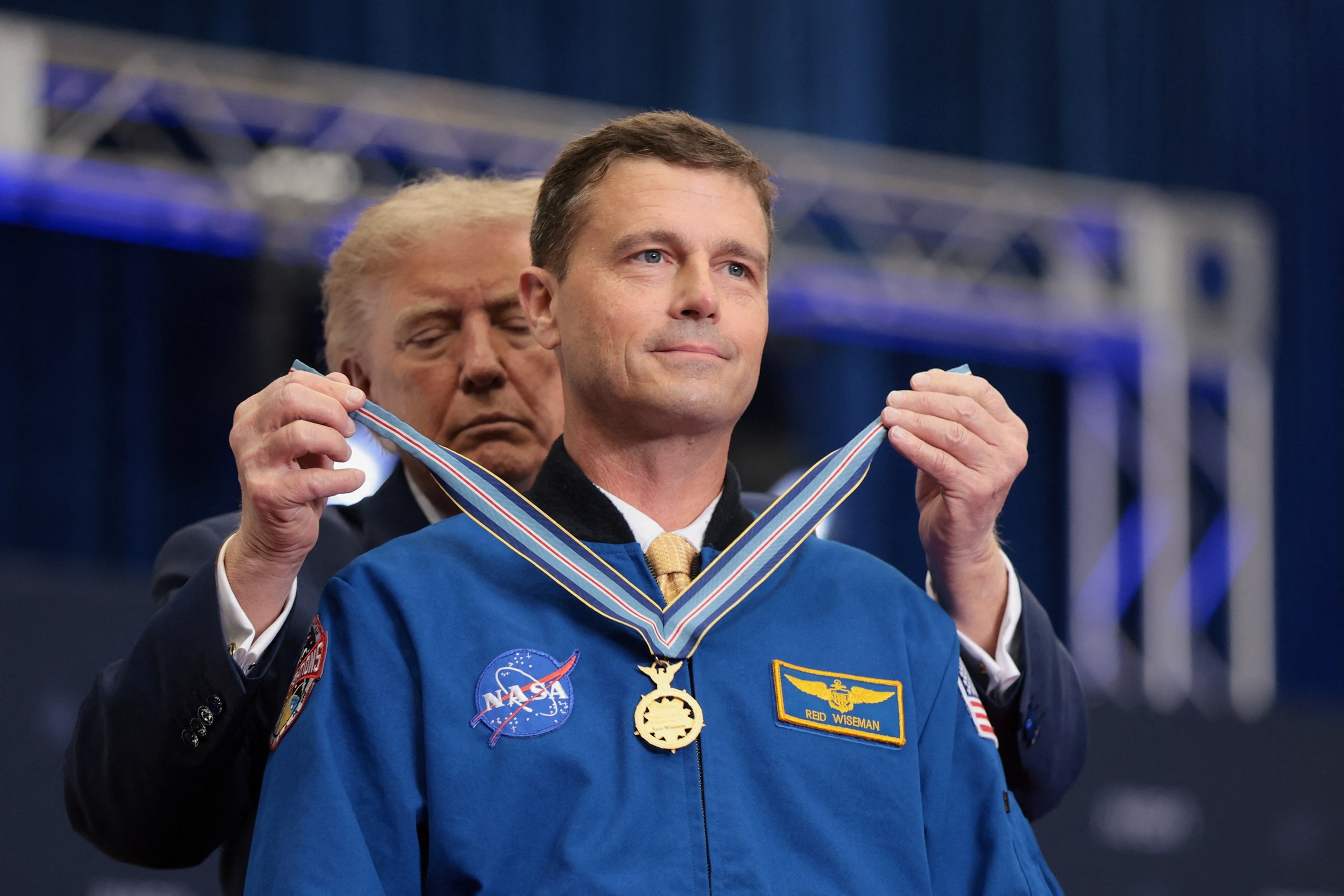 President Donald Trump presents NASA astronaut Reid Wiseman with a medal during a Congressional Space Medal of Honor presentation to the Artemis II crew at NASA's Johnson Space Center in Houston, Texas, August 28, 2026.Kylie Cooper/Reuters