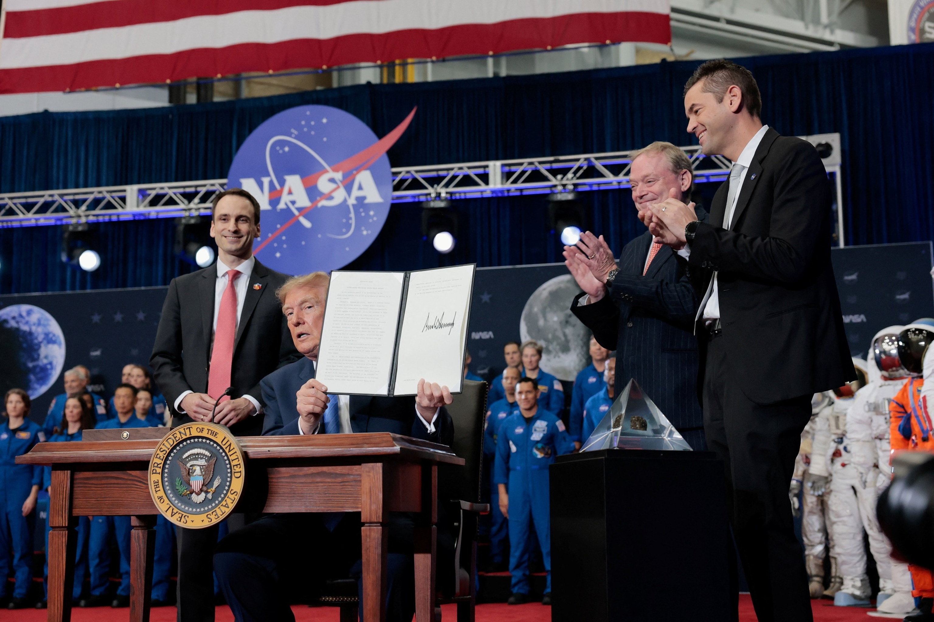 NASA Administrator Jared Isaacman applauds as President Donald Trump holds an executive order during a Congressional Space Medal of Honor presentation to the Artemis II crew at NASA's Johnson Space Center in Houston, August 28, 2026.Kylie Cooper/Reuters