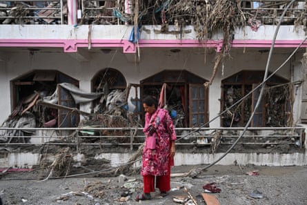 People search lists for the names of relatives rescued from cut-off areas after the flash floods in Nepal’s Nuwakot district.Photograph: Dar Yasin/AP
