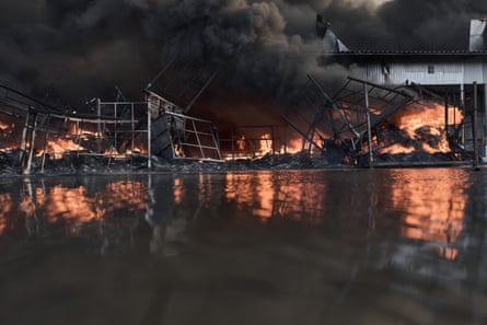 Smoke and flames rise from the warehouse after the strike in the Bucha district of the Kyiv region.Photograph: Libkos/Getty