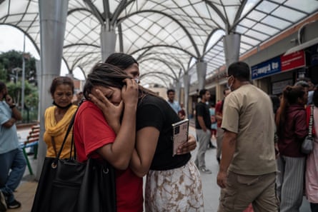 Monita Nepali, right, whose husband is missing, is comforted at the hospital in Kathmandu.Photograph: Ahmer Khan/The Guardian