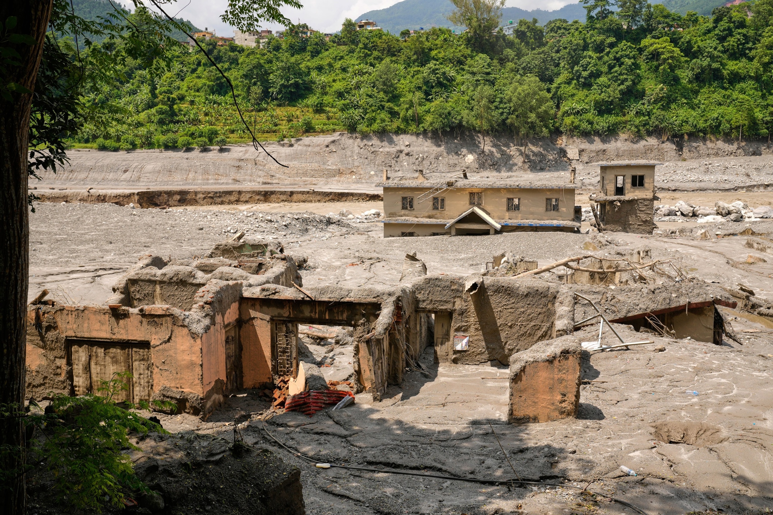 Damaged houses are seen along the river Trishuli following flash floods in Nepal's Nuwakot district, Aug. 29, 2026.Dar Yasin/AP Photo