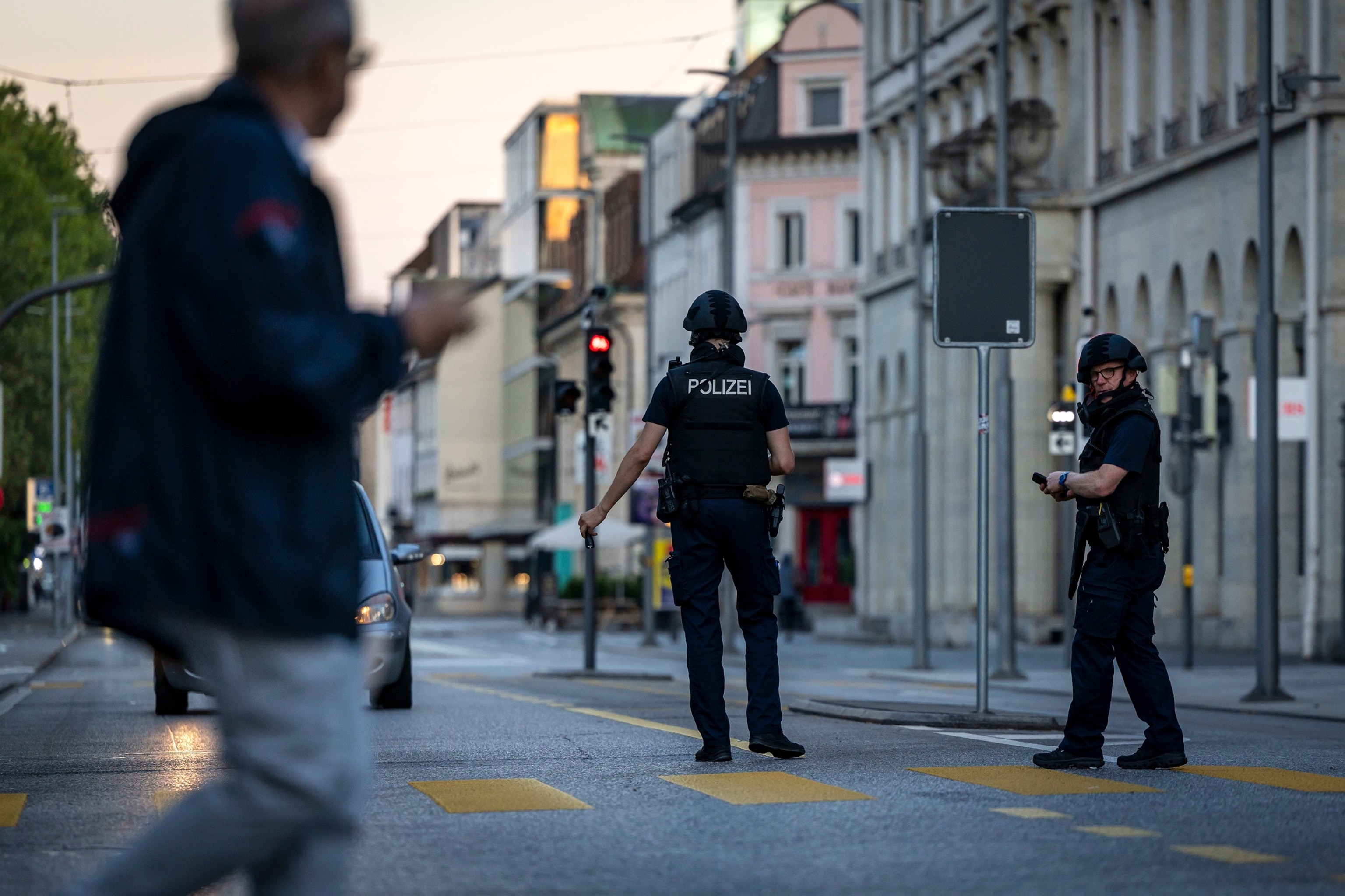 Police officers patrol a street in downtown Aarau, Switzerland Sunday, Aug. 30, 2026, following a shooting.Michael Buholzer/Keystone via AP