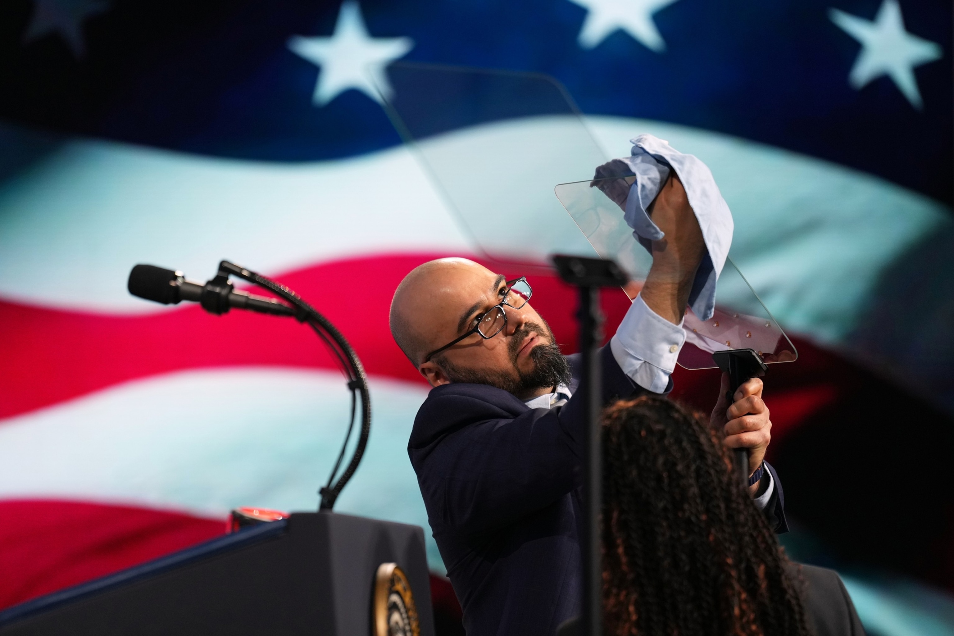 Gabriel Perez cleans the teleprompter before President Donald Trump speaks at the Future Investment Initiative Institute's summit, March 27, 2026, in Miami Beach, Fla.Mark Schiefelbein/AP Photo