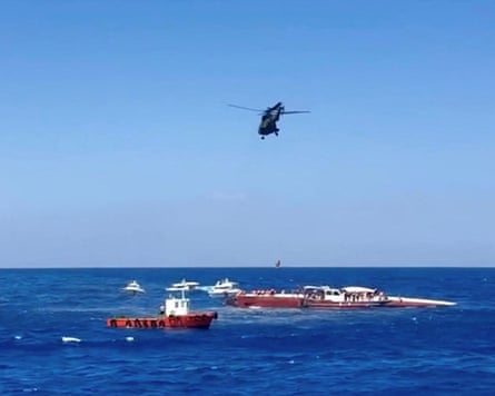 A rescue helicopter winches up a passenger.Photograph: Reuters TV/Reuters