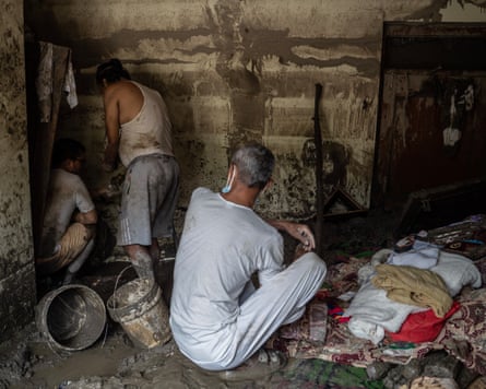 People in Devighat salvage what possessions they can from their damaged homes.Photograph: Ahmer Khan/The Guardian