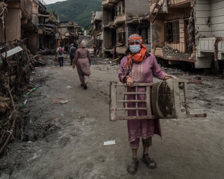 Many returned to Devighat to pack up their belongings before leaving, never to return.Photograph: Ahmer Khan/The Guardian