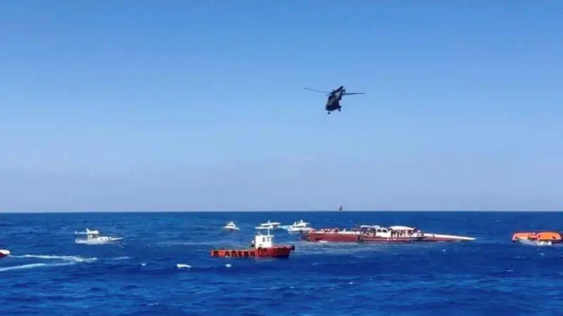 Image caption,Rescue boats and helicopter around the sinking catamaran close to the port of Kyrenia