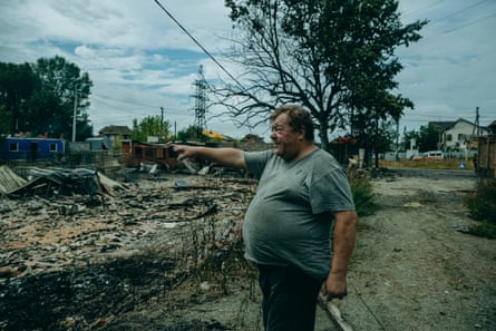 Volodymyr shows his working place where he was during the attack.Photograph: Julia Kochetova/The Guardian