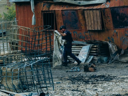 Rescue services are still working on the site.Photograph: Julia Kochetova/The Guardian