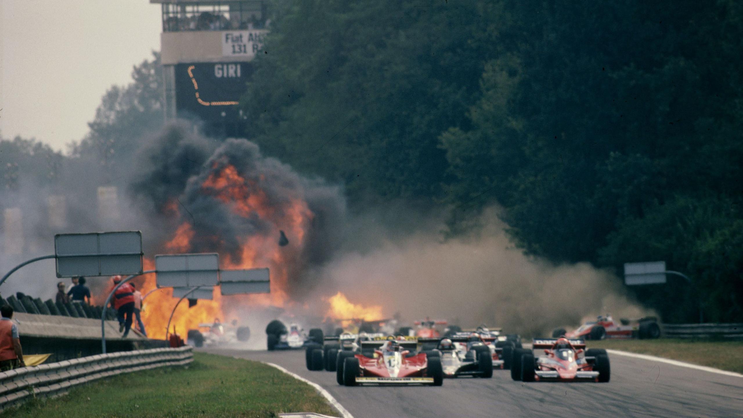 Image caption,Behind the leaders, there is a multi-car accident at the start of the 1978 Italian Grand Prix. The Lotus driver Ronnie Peterson was trapped in his wrecked Lotus with serious leg injuries and had to be freed by other drivers, but his injuries did not appear life-threatening. After significant delays in getting him treated, the Swede died from an embolism the following morning. His team-mate Mario Andretti won the world title on the day of Peterson's accident and after his death remarked: "Unfortunately, motor racing is also this."