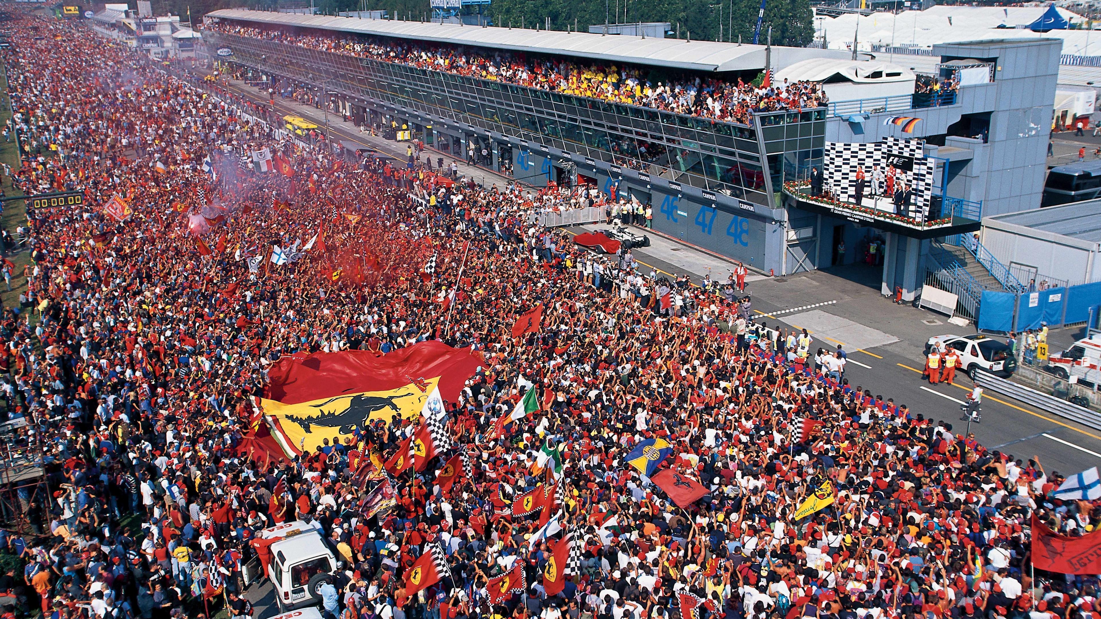Image caption,The Ferrari tifosi congregate on the start-finish straight to celebrate Michael Schumacher's victory in 2000. It was a key race on the way to the first of his five consecutive drivers' titles for the team.