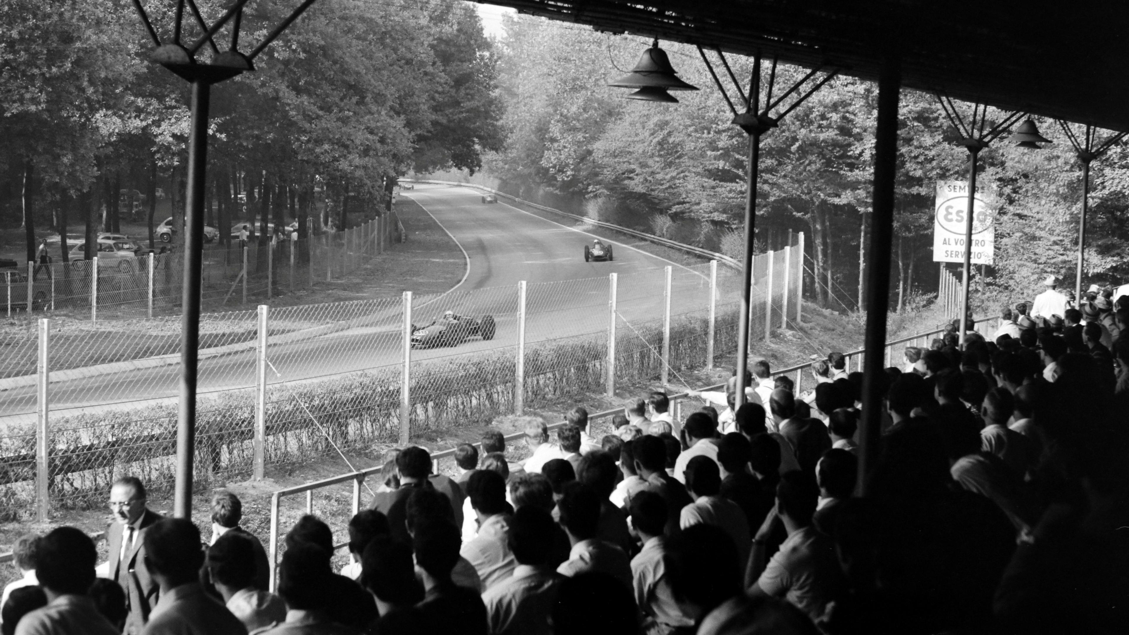 Image caption,Spectators inside a grandstand watch the action through the Lesmos corners in 1962.