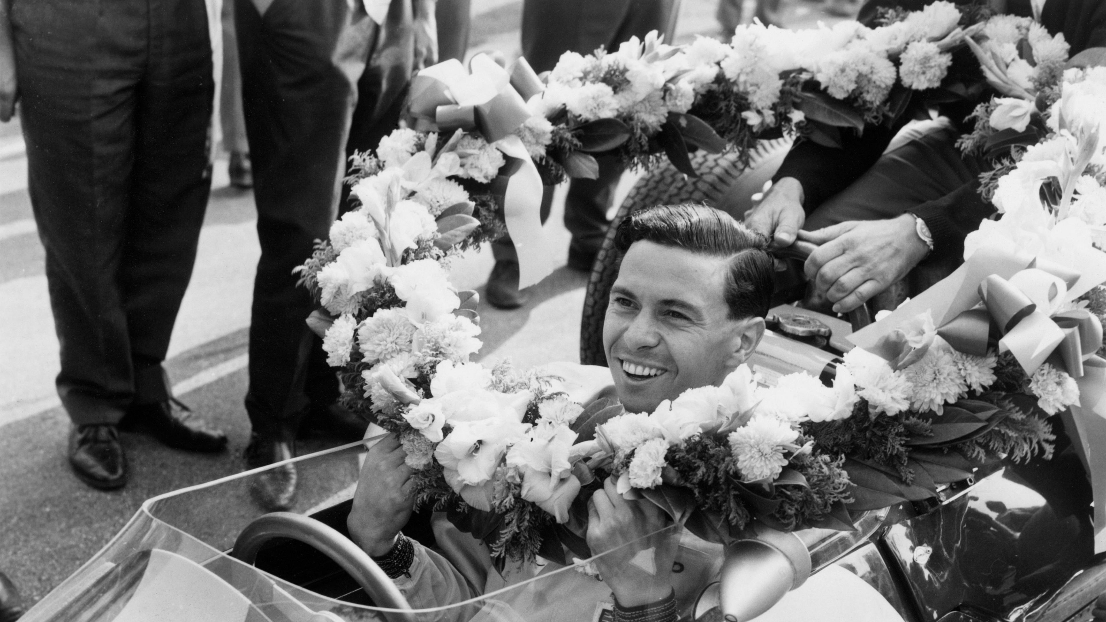 Image caption,Scotsman Jim Clark is presented with a garland after winning the 1963 grand prix to secure his first of two drivers' championships for Lotus.