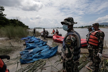 Nepali soldiers retrieve bodies of people swept away by the flash floods and a mudslide on the Narayani River.Photograph: Navesh Chitrakar/Reuters