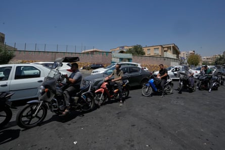 Drivers queue outside a petrol station in Tehran on Tuesday.Photograph: Vahid Salemi/AP