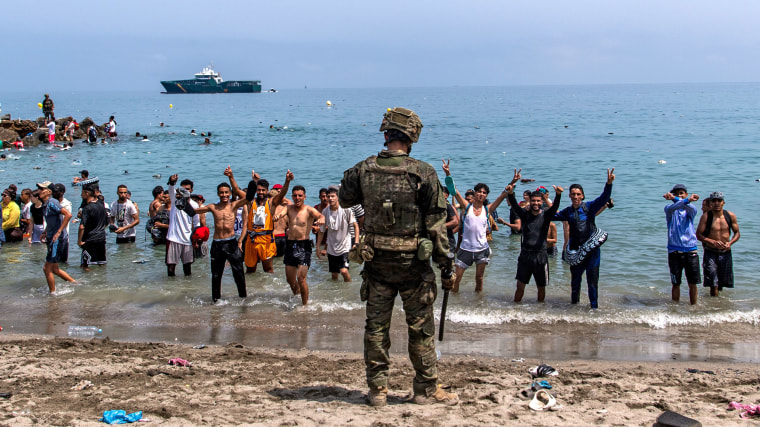 Spanish army soldiers block access to the beach for people crossing into Cueta from Morocco.Antonio Sempere / AP
