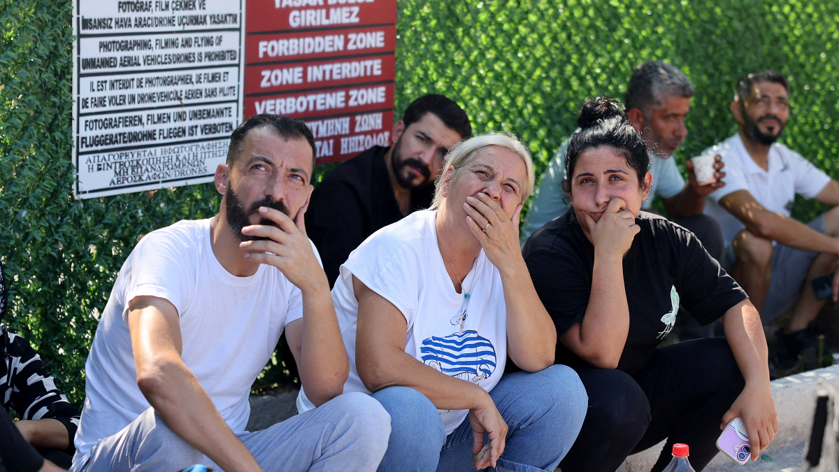 Image caption,Survivors continue to wait for news of their missing relatives at the port in Kyrenia