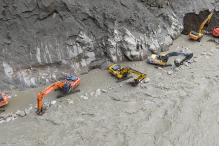 Excavators repairing a section of damaged road to restore access to Gyirong Port.Photograph: Xinhua/Shutterstock