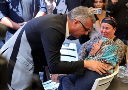 The Turkish Cypriot leader, Tufan Erhürman, talks with relatives waiting for news outside the port of Kyrenia.Photograph: Yiannis Kourtoglou/Reuters