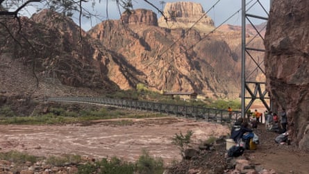 People wait near a bridge as a helicopter flies nearby.Photograph: Wieke De Boer/Reuters