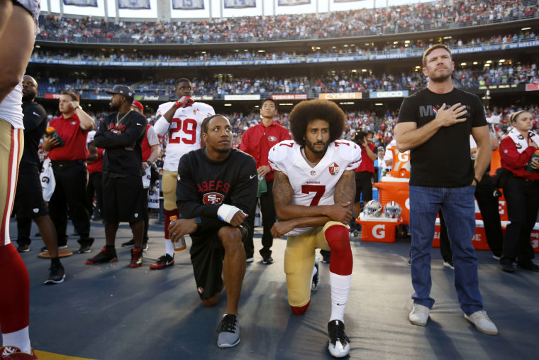 Eric Reid and Colin Kaepernick kneel in protest during the national anthem in San Diego on Sept. 1, 2016.Michael Zagaris / San Francisco 49ers via Getty Images file
