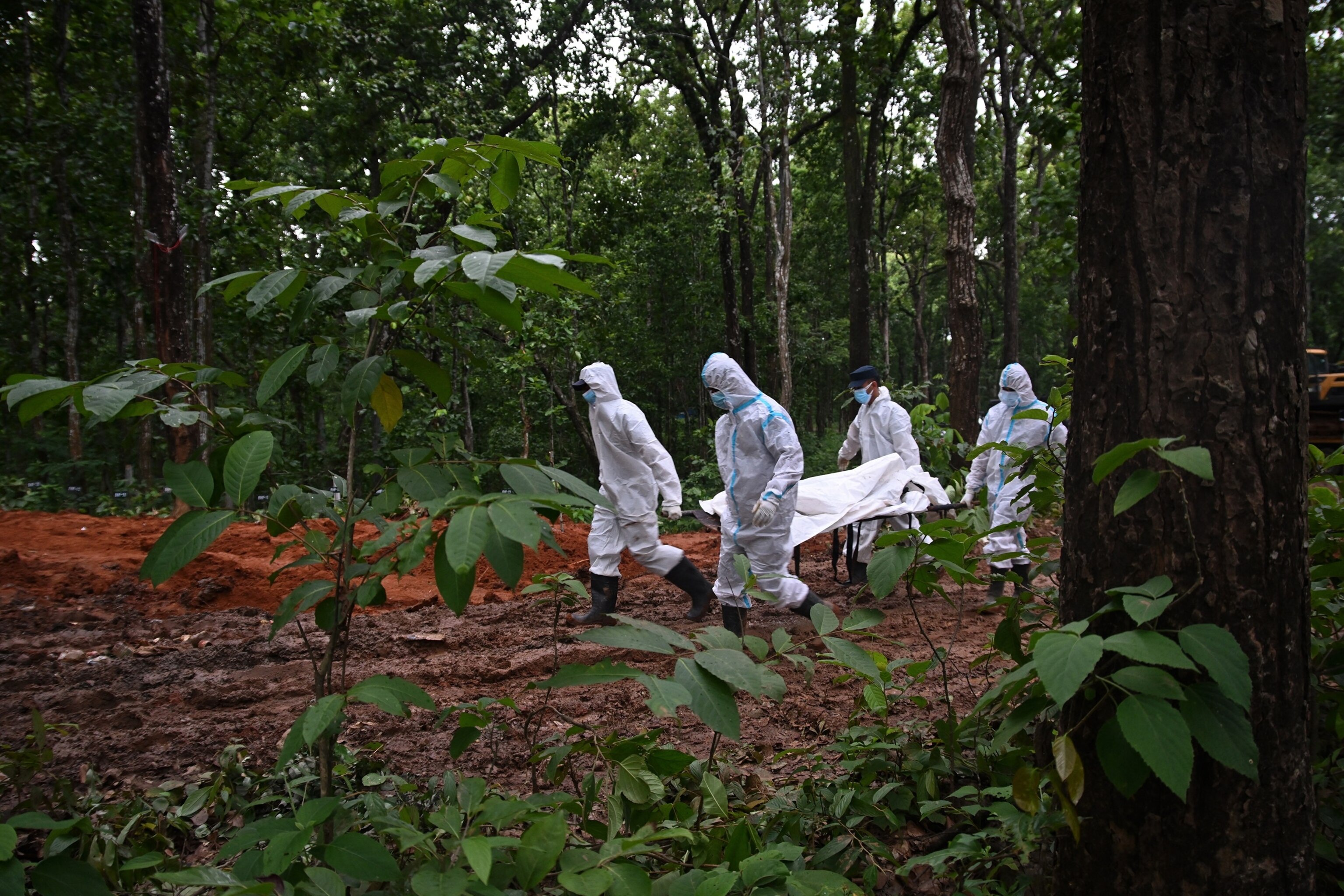 Security personnel carry body parts of unidentified flood victims, at a mass burial site in Devghat, in Nepal's Chitwan district on August 31, 2026.Prakash Mathema/AFP via Getty Images
