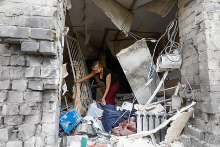A woman collects belongings from her apartment damaged by a Russian missile strike in the town of Boryspil in the Kyiv region.Photograph: Valentyn Ogirenko/Reuters