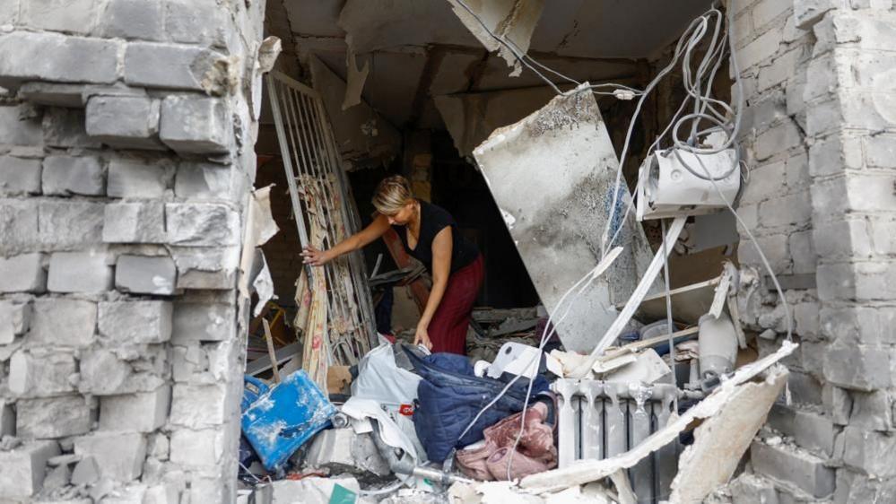 Image caption,Four people were killed in overnight Russian strikes on Ukraine's town of Boryspil, outside Kyiv