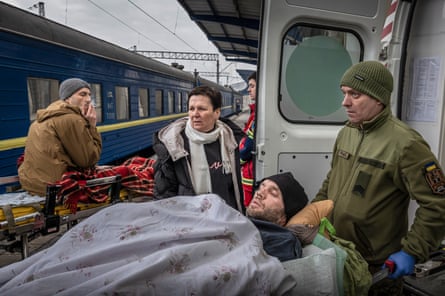 A wounded Ukrainian soldier is evacuated on a train.Photograph: Jelle Krings