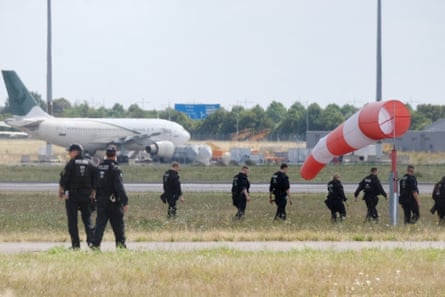 Police officers searching for evidence at Leipzig/Halle airport in August.Photograph: Sebastian Willnow/DPA/AP
