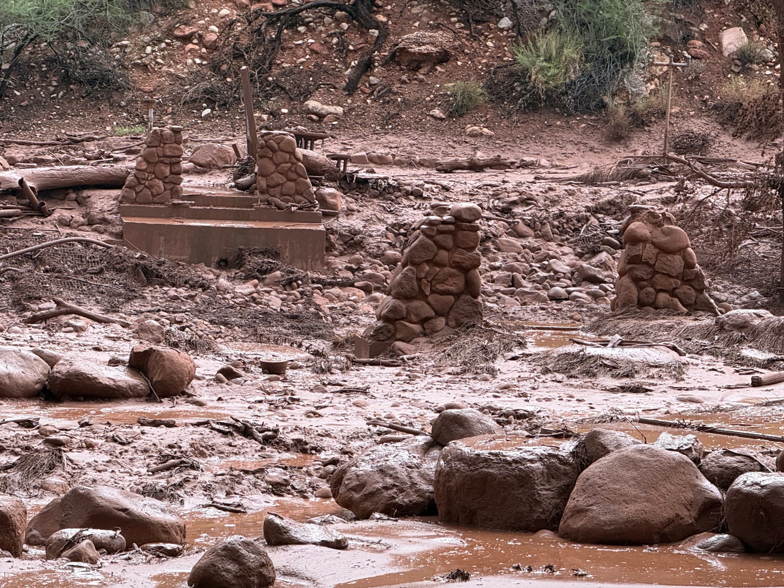 This handout image released by the Grand Canyon National Park Service via X (formerly Twitter) on August 30, 2026 shows remnants of stone bridge pylons along Bright Angel Creek following a flash flood that destroyed the footbridge on August 29. More than 20 people may be missing after the flash flood in Grand Canyon National Park according to the National Park Service. The floods hit the Bright Angel Canyon and Phantom Ranch area on Saturday, the service said, adding that it was working with Arizona authorities to evacuate people and account for individuals in the affected area.J. Thompson/NATIONAL PARK SERVICE/AFP via Getty