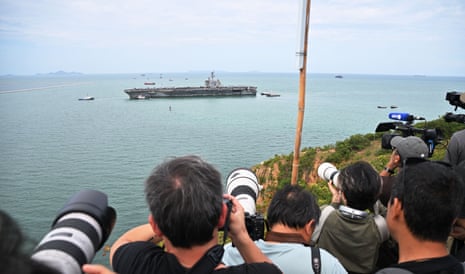 A tug boat greets the USS Abraham Lincoln as it arrives at the port in Laem Chabang, Chonburi, Thailand.Photograph: Sakchai Lalit/AP