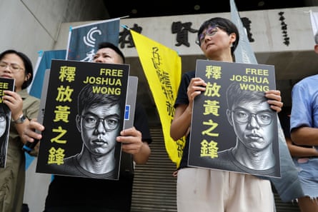 Hong Kong activist and supporters hold signs during a press event to support pro-democracy activist Joshua Wong in Taipei, Taiwan, on Wednesday.Photograph: Chiang Ying-ying/AP