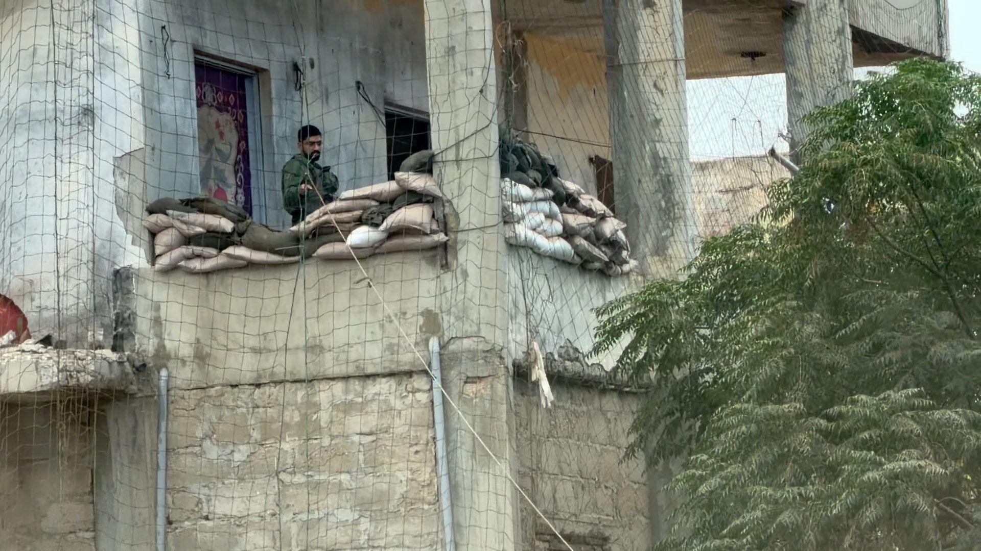 Image caption,An Israeli soldier at a checkpoint established in a residential building near the Unifil headquarters in Naqoura