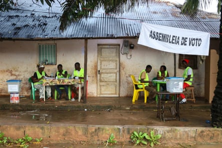 Election officials wait for voters to cast their ballots in the referendum in Bissau. The turnout was reportedly over 55% of the population.Photograph: Darcicio Barbosa/AP