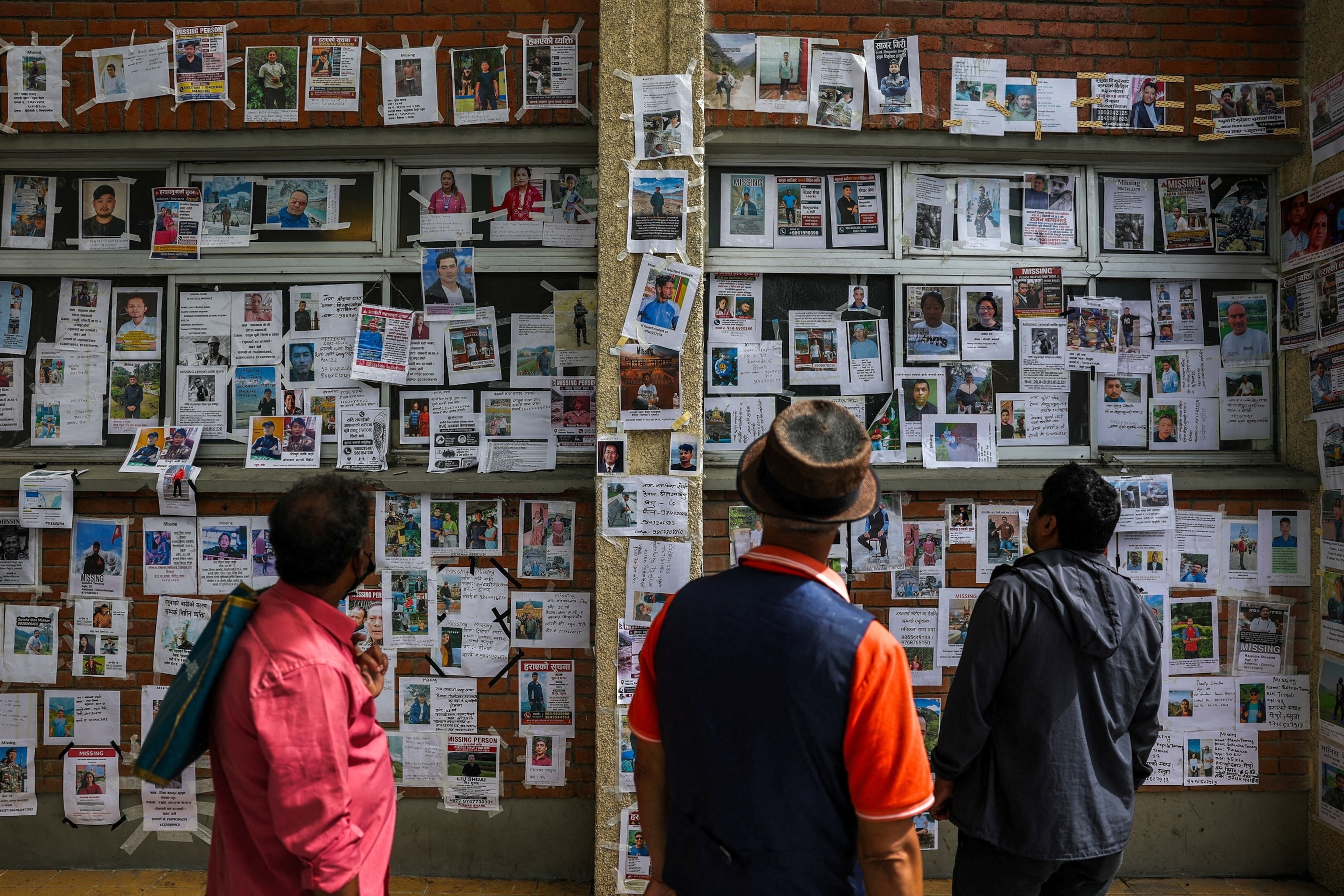 People look at photographs of missing people on a wall outside Tribhuvan University Teaching Hospital following the deadly flash floods and mudslide, reacts outside Tribhuvan University Teaching Hospital, in Kathmandu, Nepal, September 2, 2026.Athit Perawongmetha/Reuters
