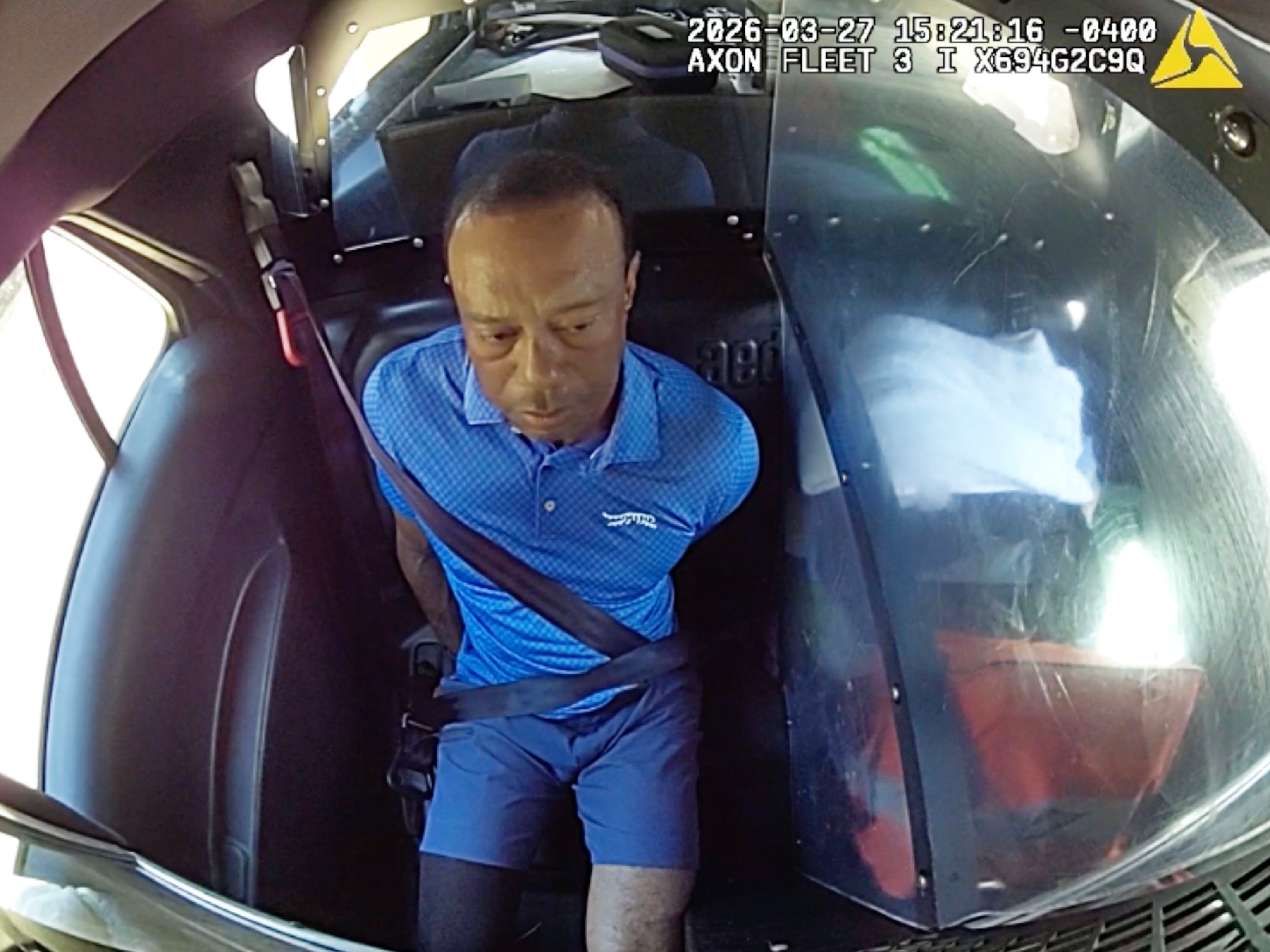 Tiger Woods is shown in the back of a patrol car during his arrest in Juniper, Florida, on March 27, 2026.Martin County Sheriff's Office