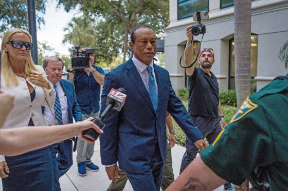 Tiger Woods stands by his overturned vehicle in Jupiter Island, Fla., on March 27.Jason Oteri / AP