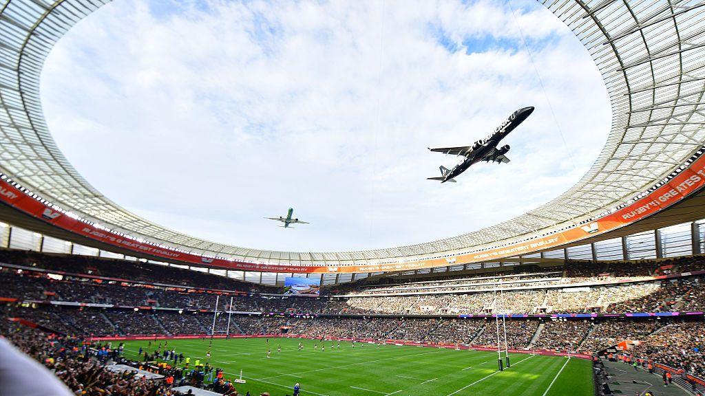 Image caption,The planes - one green, one black - flew over the stadium shortly before the start of the South Africa-New Zealand match