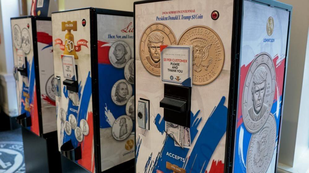 Image caption,Vending machines selling Trump $1 coins at the US Mint store in Washington DC