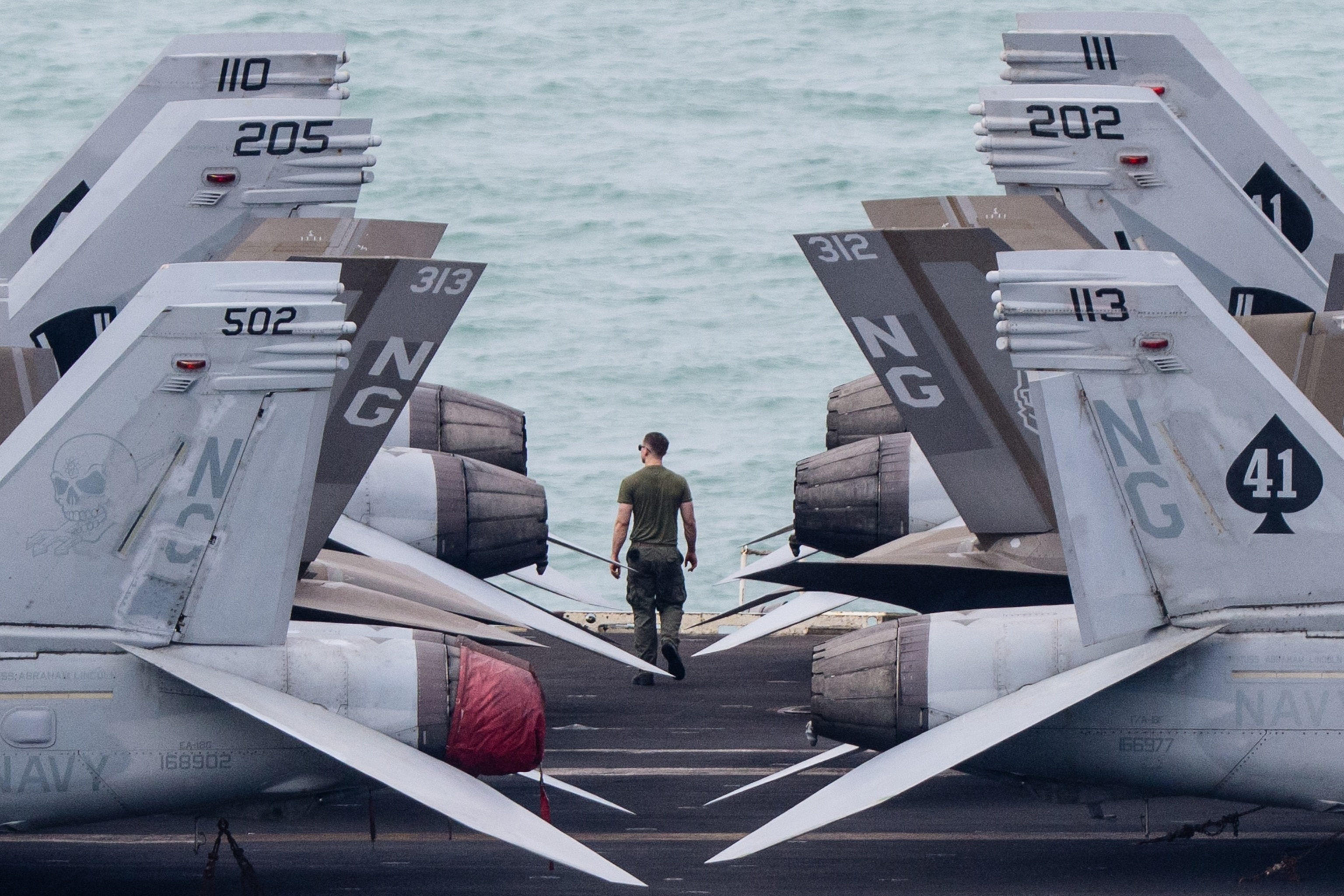 A crew member walks on the flight deck of US nuclear-powered aircraft carrier USS Abraham Lincoln as it heads towards Laem Chabang Port, near the city of Pattaya, September 2, 2026.Anthony Wallace/AFP via Getty Images