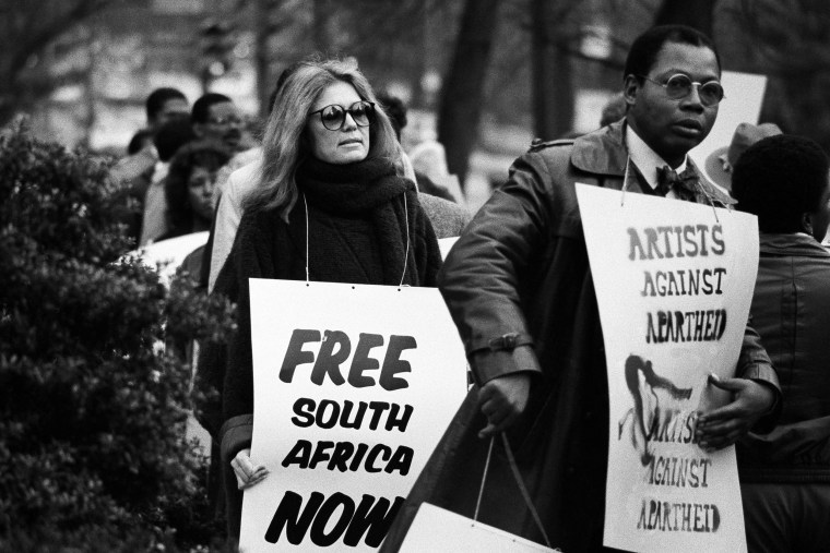 Gloria Steinem walks a picket line outside the South African Embassy in Washington in 1984.AP file