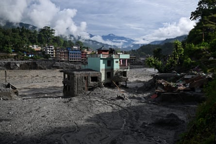 A turquoise-green house stands tall amid sludge near Trishuli River in the aftermath of flash floods.Photograph: Arun Sankar/AFP/Getty Images