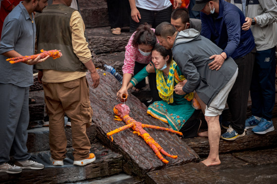 A relative mourns during the symbolic cremation of four members of the Magar family who remain missing after the flash floods, using effigies made of Kush grass, at Pashupatinath Temple on September 02, 2026 in Kathmandu, Nepal. The floods, triggered by a glacier collapse on Langtang Lirung on August 26, have killed at least 900 people and left nearly 4,000 missing in Nepal as of September 1, with additional deaths and hundreds missing in neighboring Tibet, authorities have said.Ezra Acayan / Getty Images