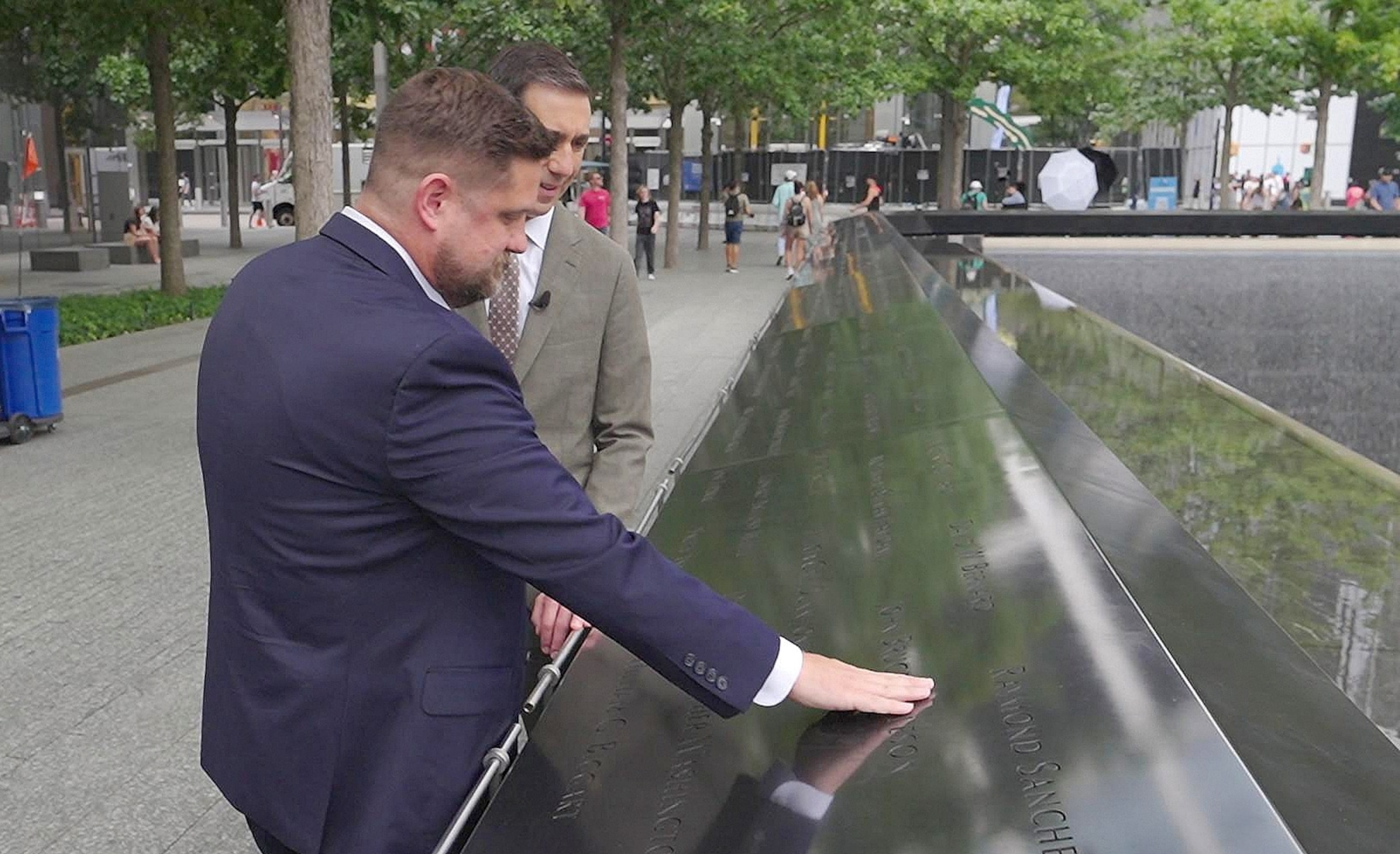 Brett Eagleson touches his father's name at the 9/11 Memorial reflecting pools, in advance of the 25th anniversary of the attacks.ABC News