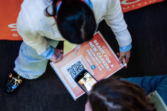 A jobseeker scans a QR code while speaking to a recruiter during the WorkSource North Seattle Career Fair in Seattle, Washington, US, on Tuesday, Feb. 10, 2026.David Ryder / Bloomberg via Getty Images file